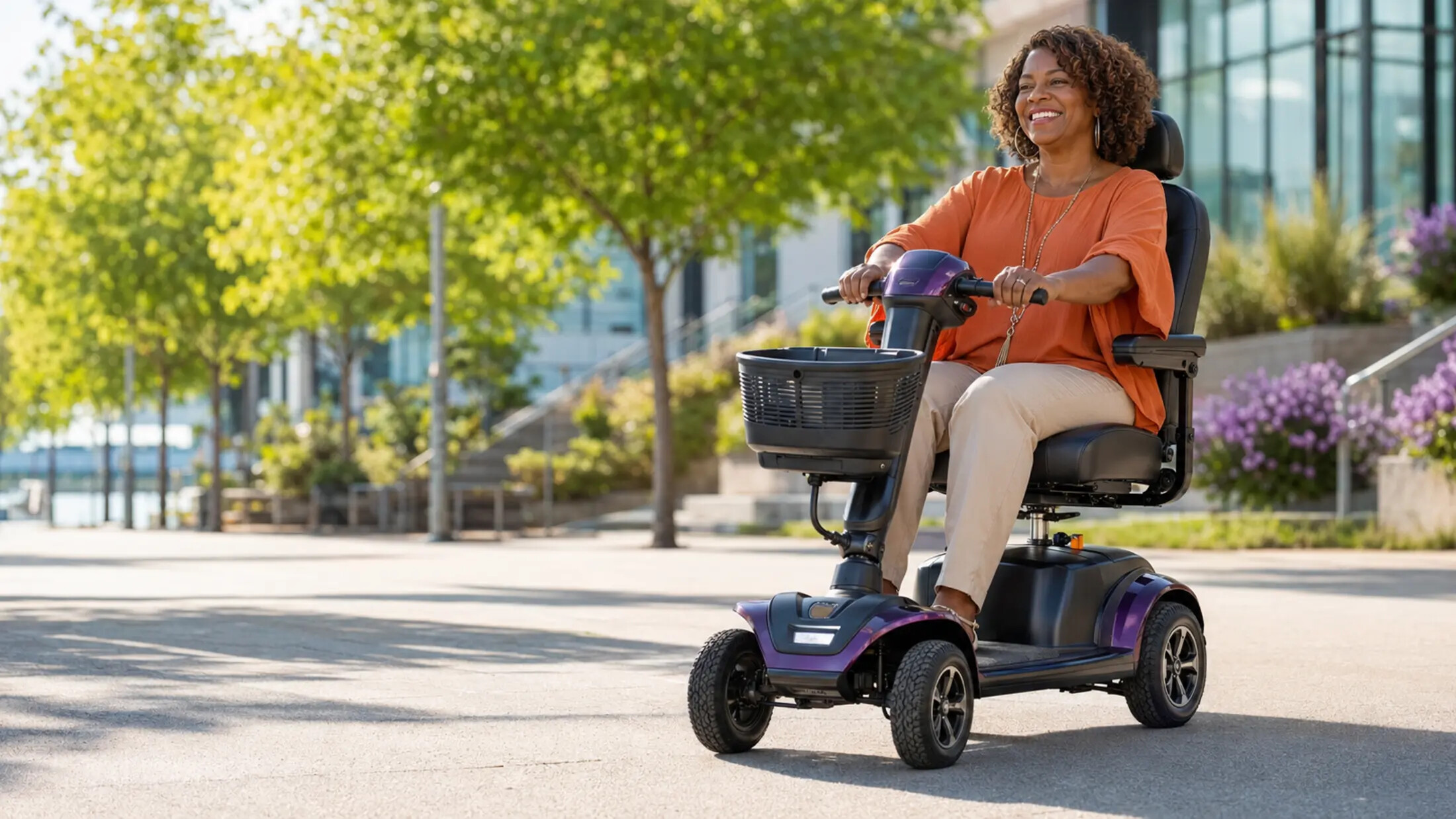 African American woman smiling while riding a modern electric mobility scooter outdoors